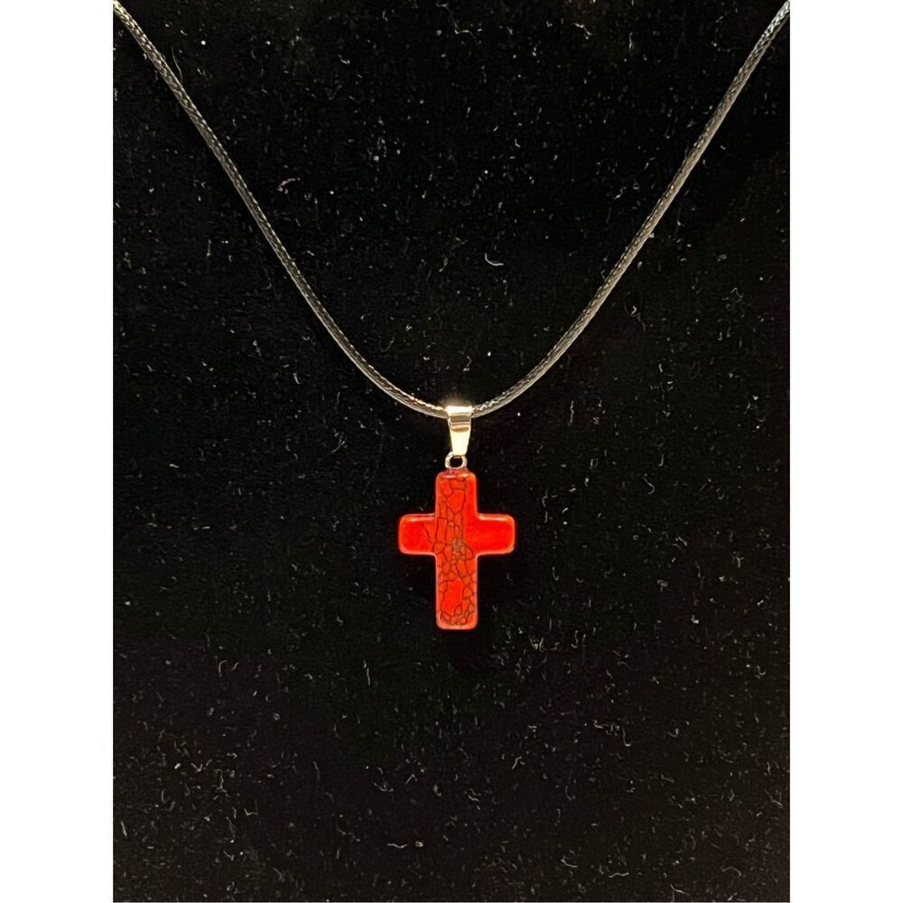 Red Stone Cross on a Black Necklace Cord
